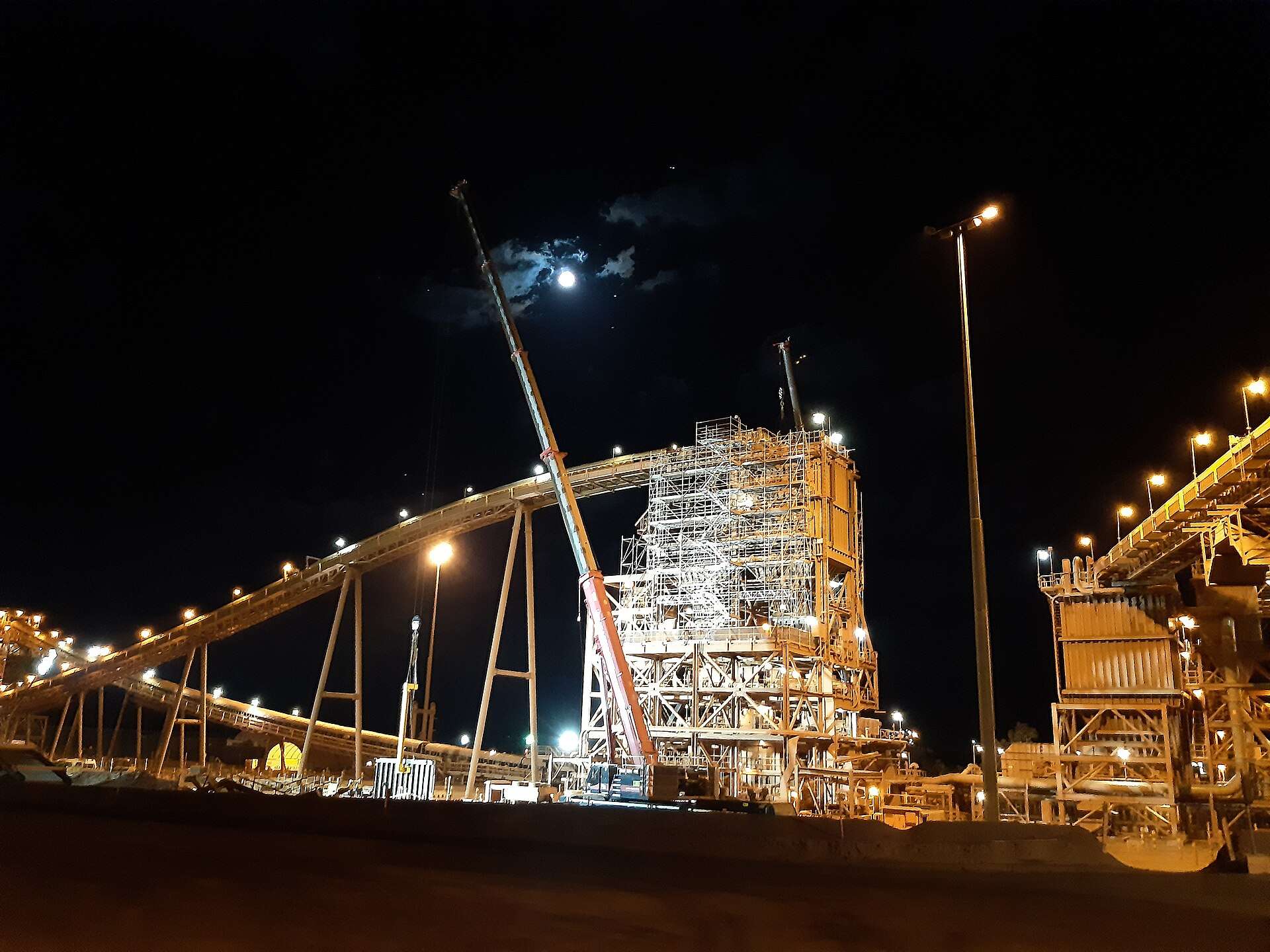 The Brockman 4 secondary crusher building covered in scaffolding at night, Pilbara, WA